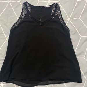 Flowy black sleeveless blouse with lace pattern outline and back button size L